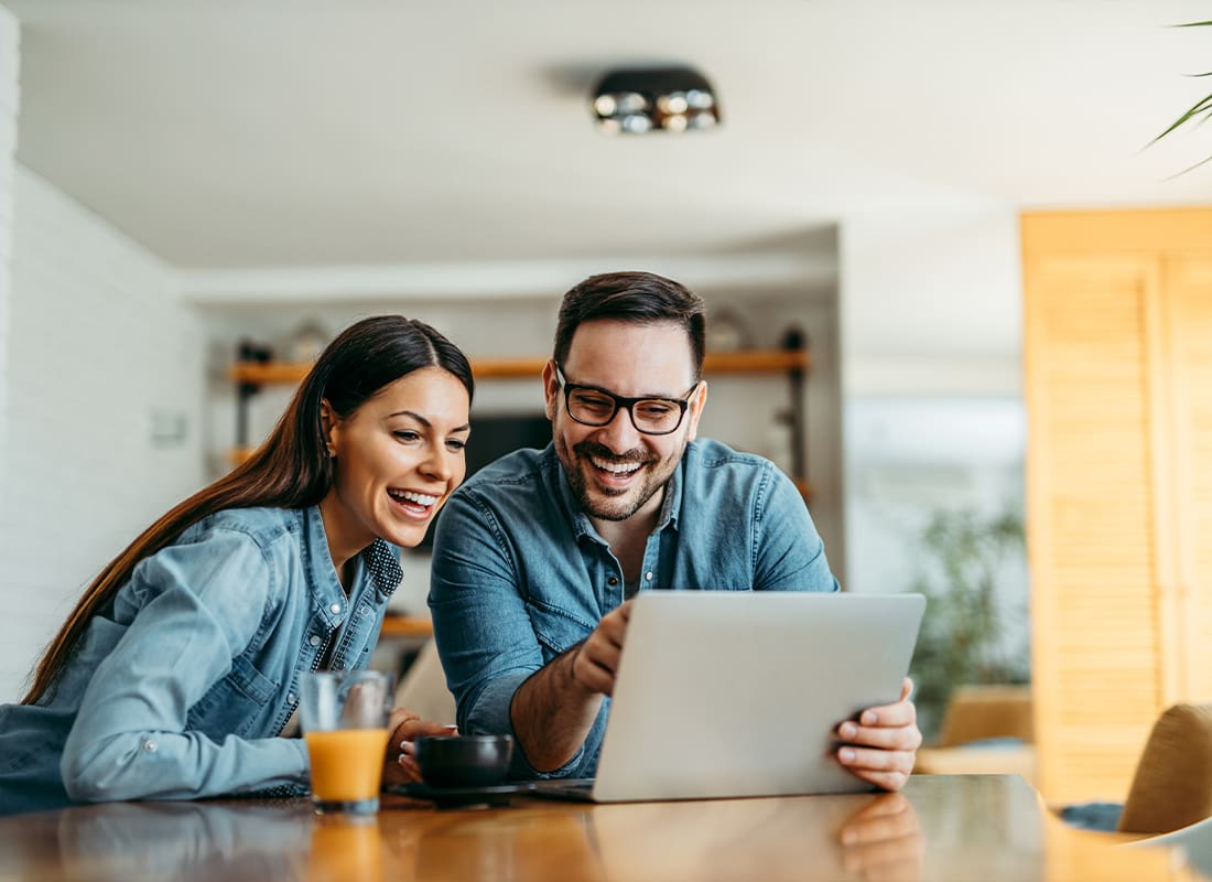 Church Insurance Resources - Young Couple Looking at Laptop Together at Home