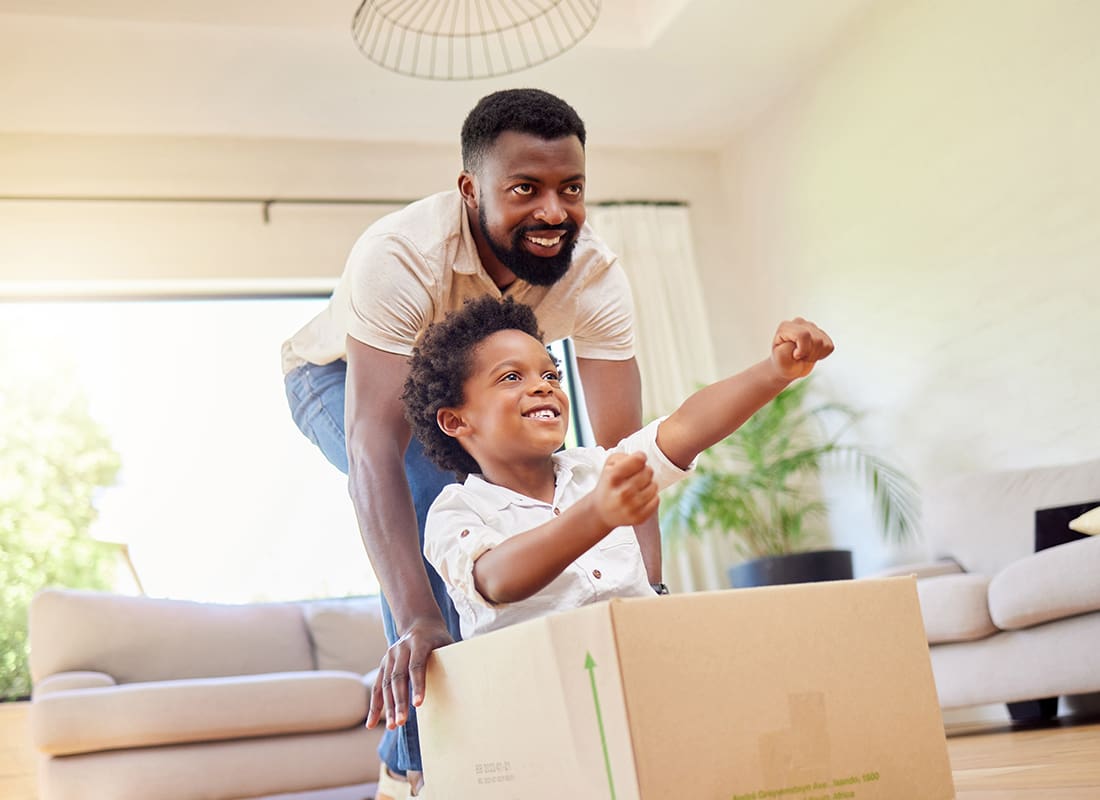 Personal Insurance - Father Playing With Son in a Cardboard Box in New Home