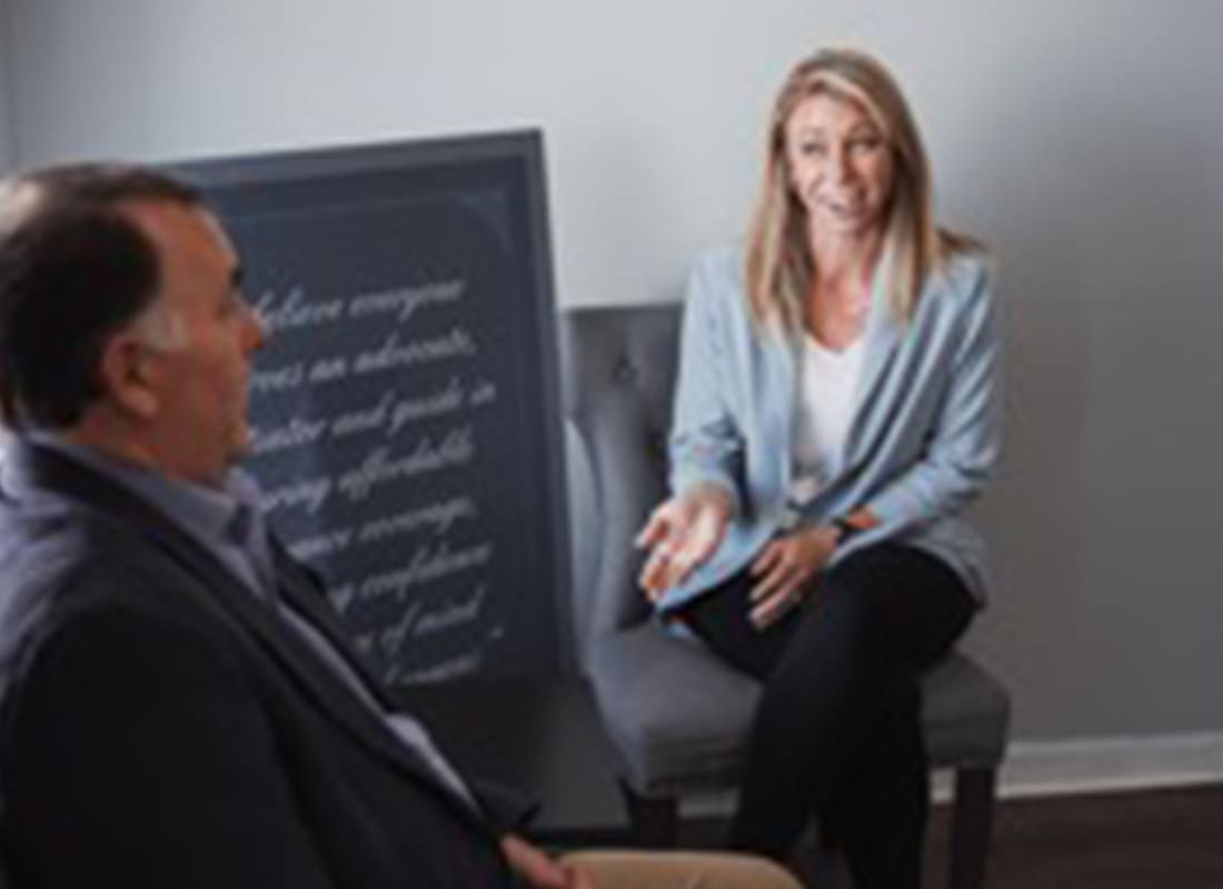 Webb Pickard Insurance & Investment Services, Inc - Team Member Talking and Sitting With a Client